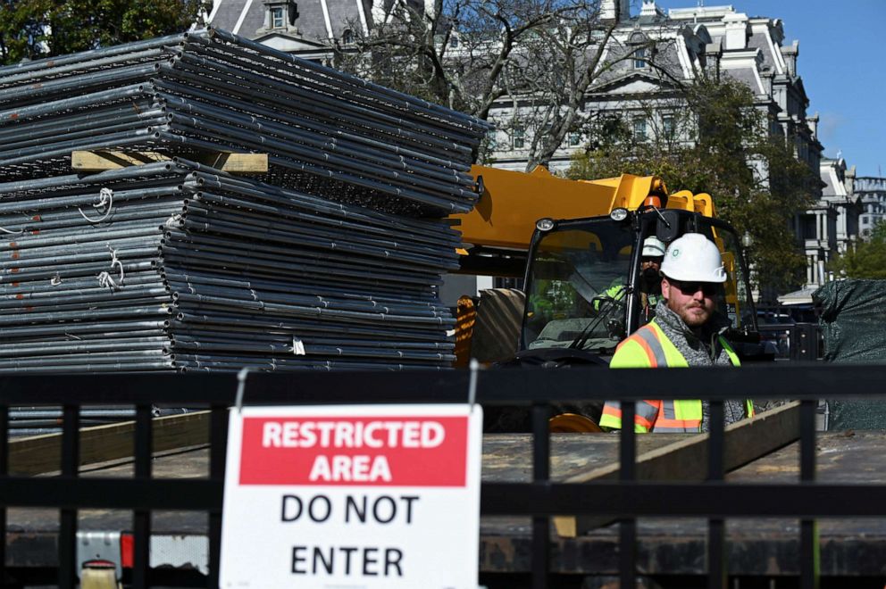 PHOTO: Workers move a stack of fencing near a security checkpoint on the South side of the White House, the day before the presidential election, in Washington, Nov. 2, 2020.