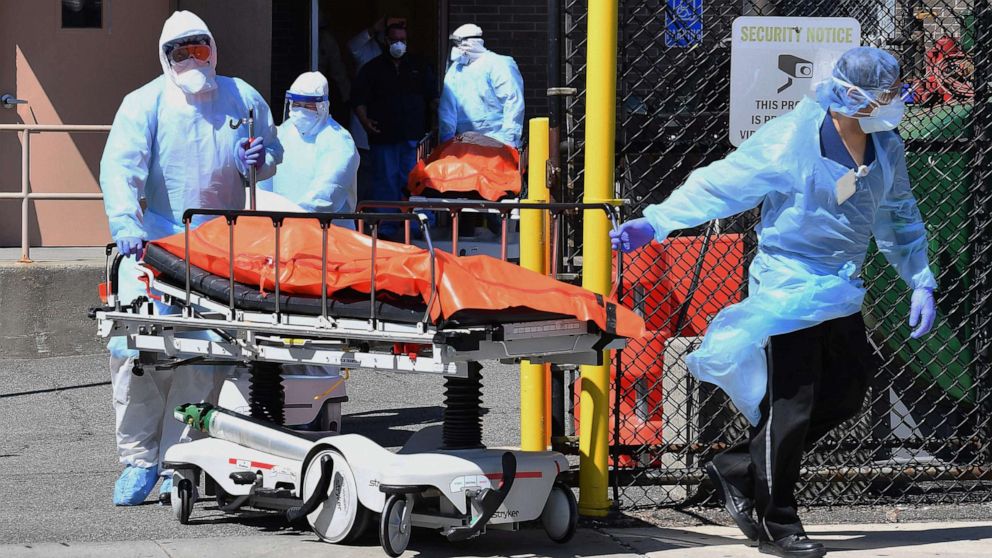 PHOTO: Medical staff move bodies from the Wyckoff Heights Medical Center to a refrigerated truck, on April 2, 2020, in Brooklyn, New York.