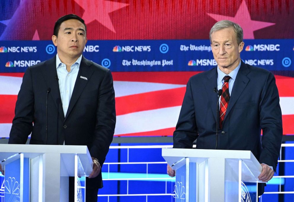 PHOTO: Democratic presidential hopefuls tech entrepreneur Andrew Yang and billionaire-philanthropist Tom Steyer speak during the fifth Democratic primary debate of the 2020 presidential campaign season in Atlanta, Nov. 20, 2019.