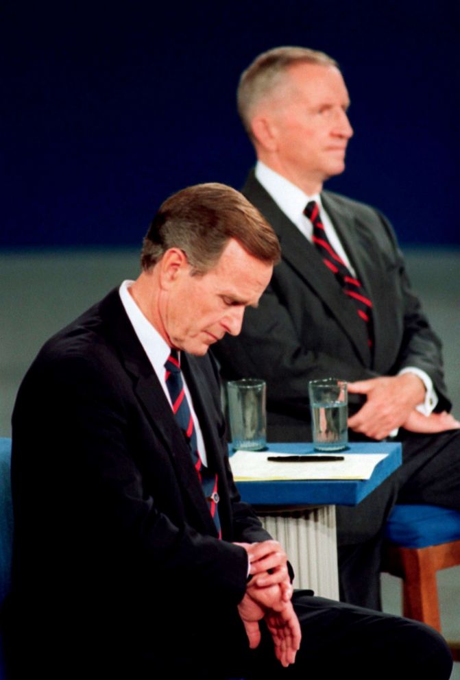 PHOTO: President George H.W. Bush looks at his watch during the 1992 presidential campaign debate with other candidates, Independent Ross Perot, top, and Democrat Bill Clinton, at the University of Richmond, Va. on Oct. 15, 1992.