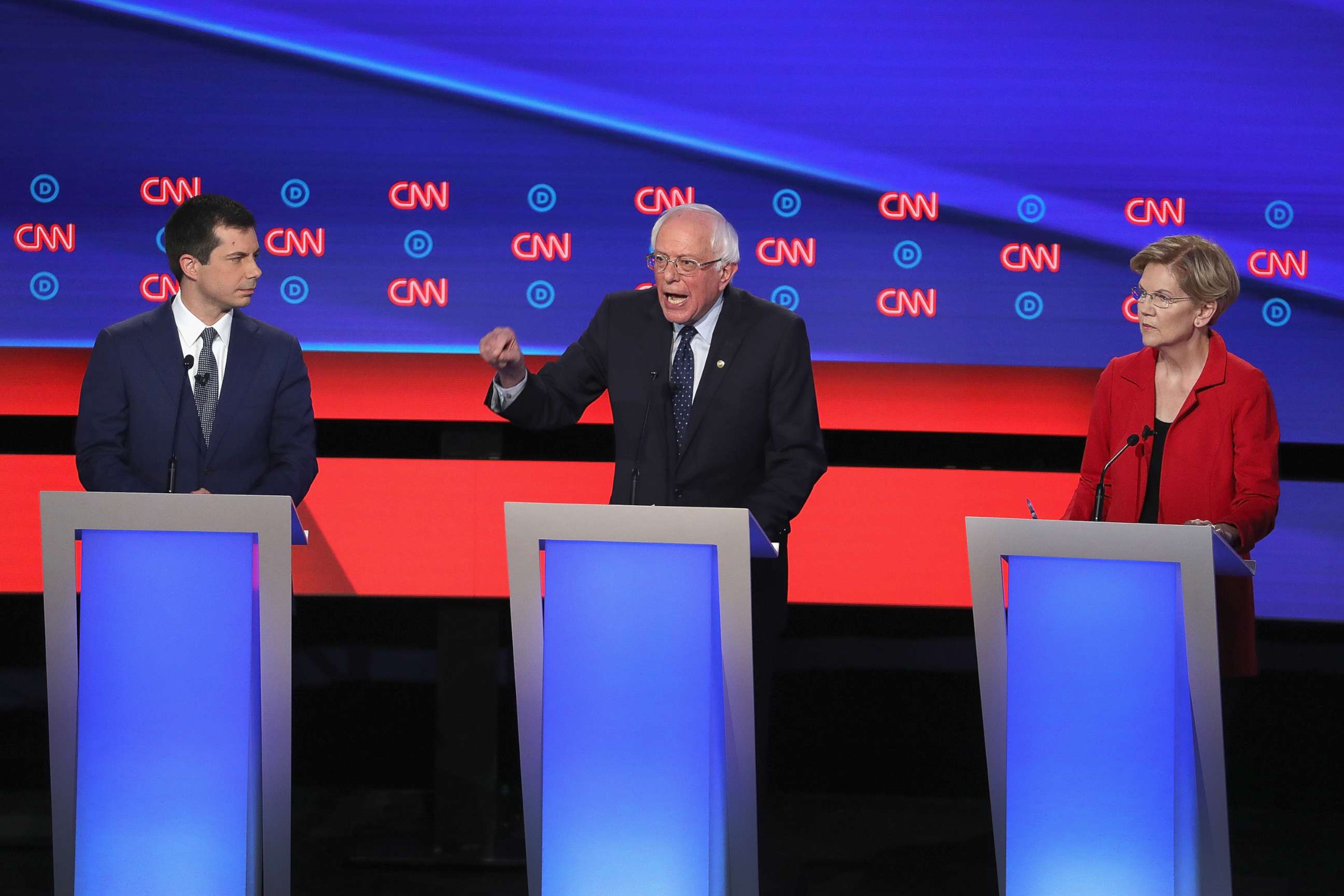 PHOTO: Democratic presidential candidates Sen. Bernie Sanders (I-VT) (C) speaks while Sen. Elizabeth Warren (D-MA) and South Bend, Indiana Mayor Pete Buttigieg (L) listen at the beginning of  the Democratic Presidential Debate, July 30, 2019, in Detroit.