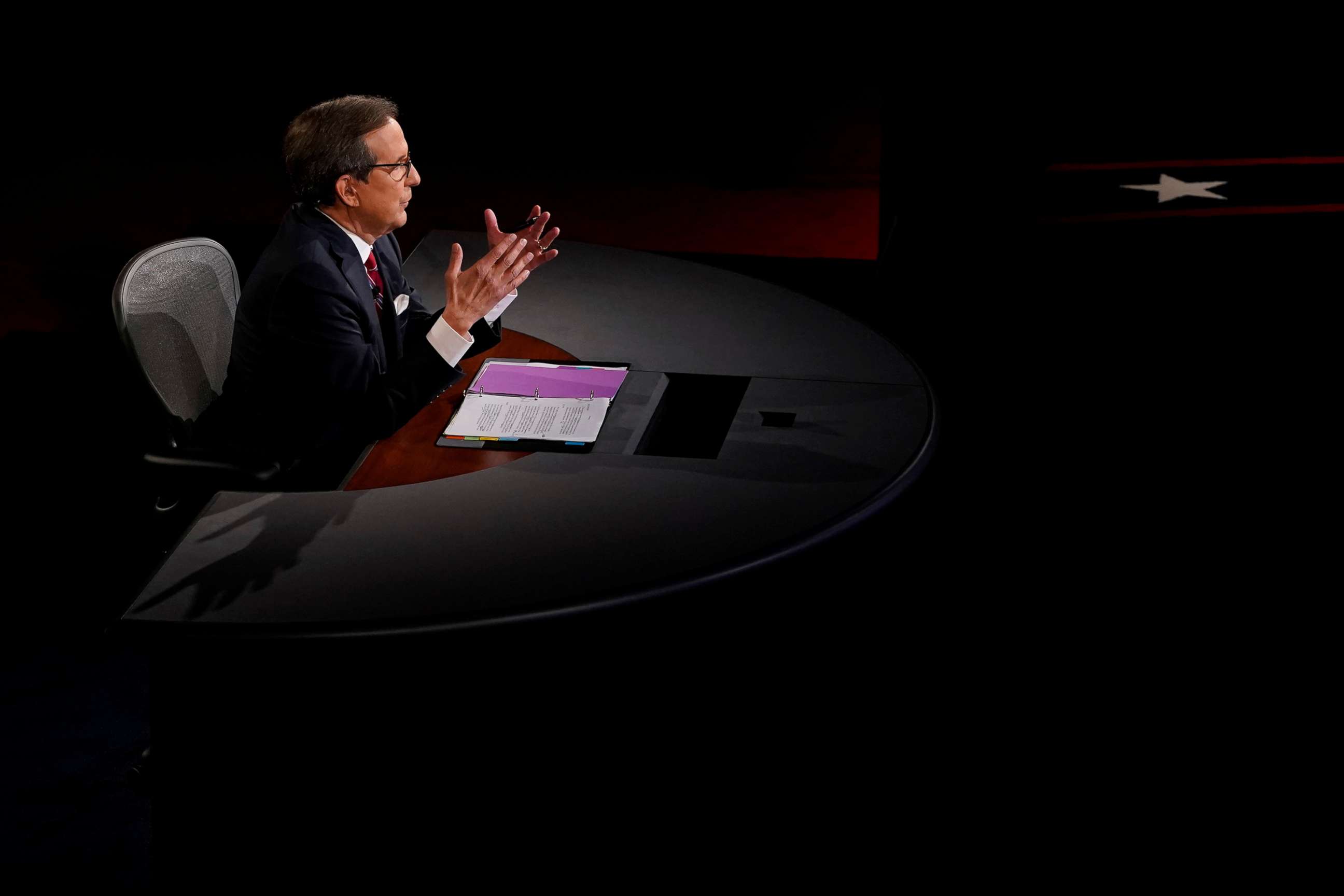 PHOTO: Debate moderator and Fox News anchor Chris Wallace directs the first 2020 presidential campaign debate between U.S. President Donald Trump and Democratic presidential nominee Joe Biden in Cleveland, Sept. 29, 2020. 