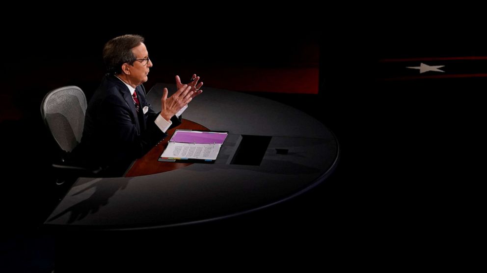 PHOTO: Debate moderator and Fox News anchor Chris Wallace directs the first 2020 presidential campaign debate between U.S. President Donald Trump and Democratic presidential nominee Joe Biden in Cleveland, Sept. 29, 2020. 
