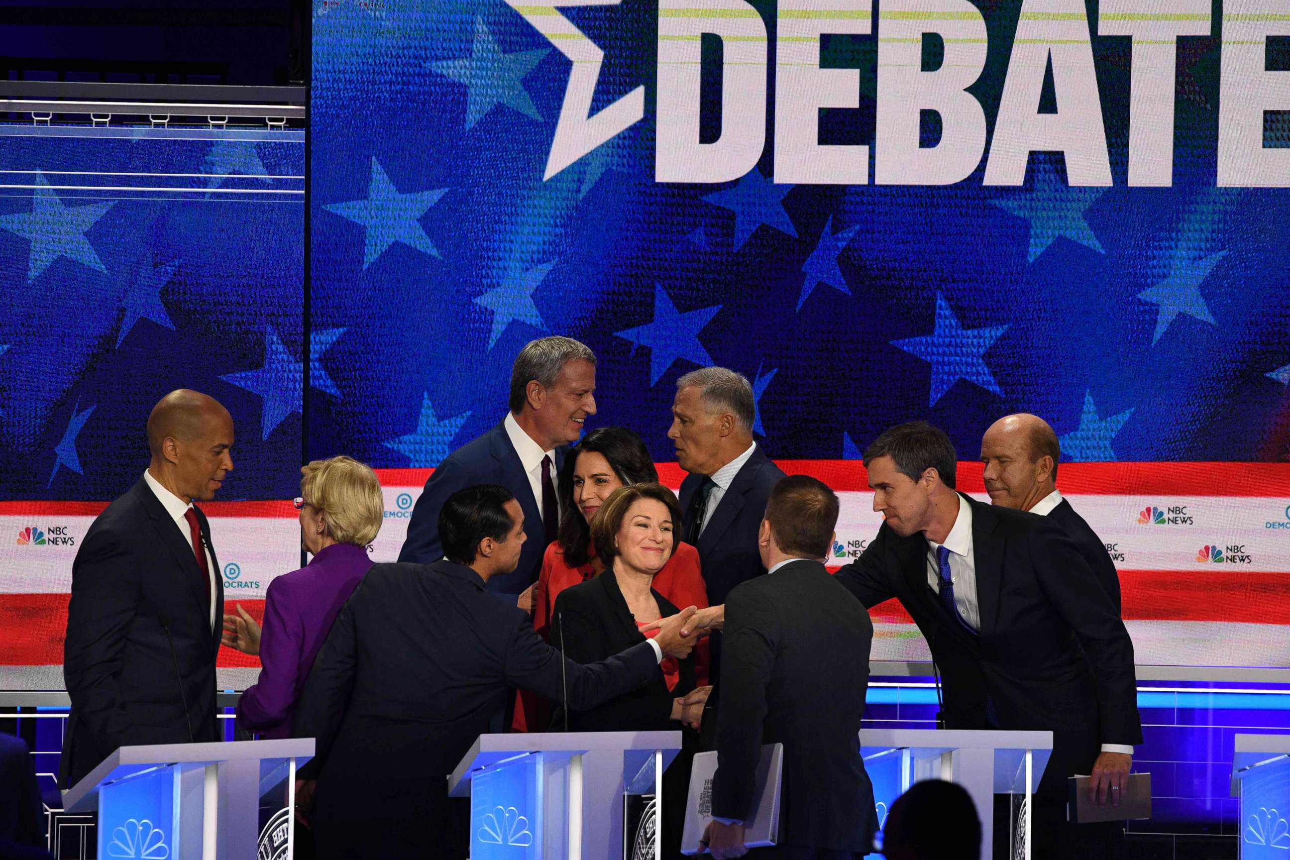 PHOTO: Democratic presidential hopefuls greet each other at the end of the first night of the Democratic presidential primary debate hosted by NBC News at the Adrienne Arsht Center for the Performing Arts in Miami, June 26, 2019.