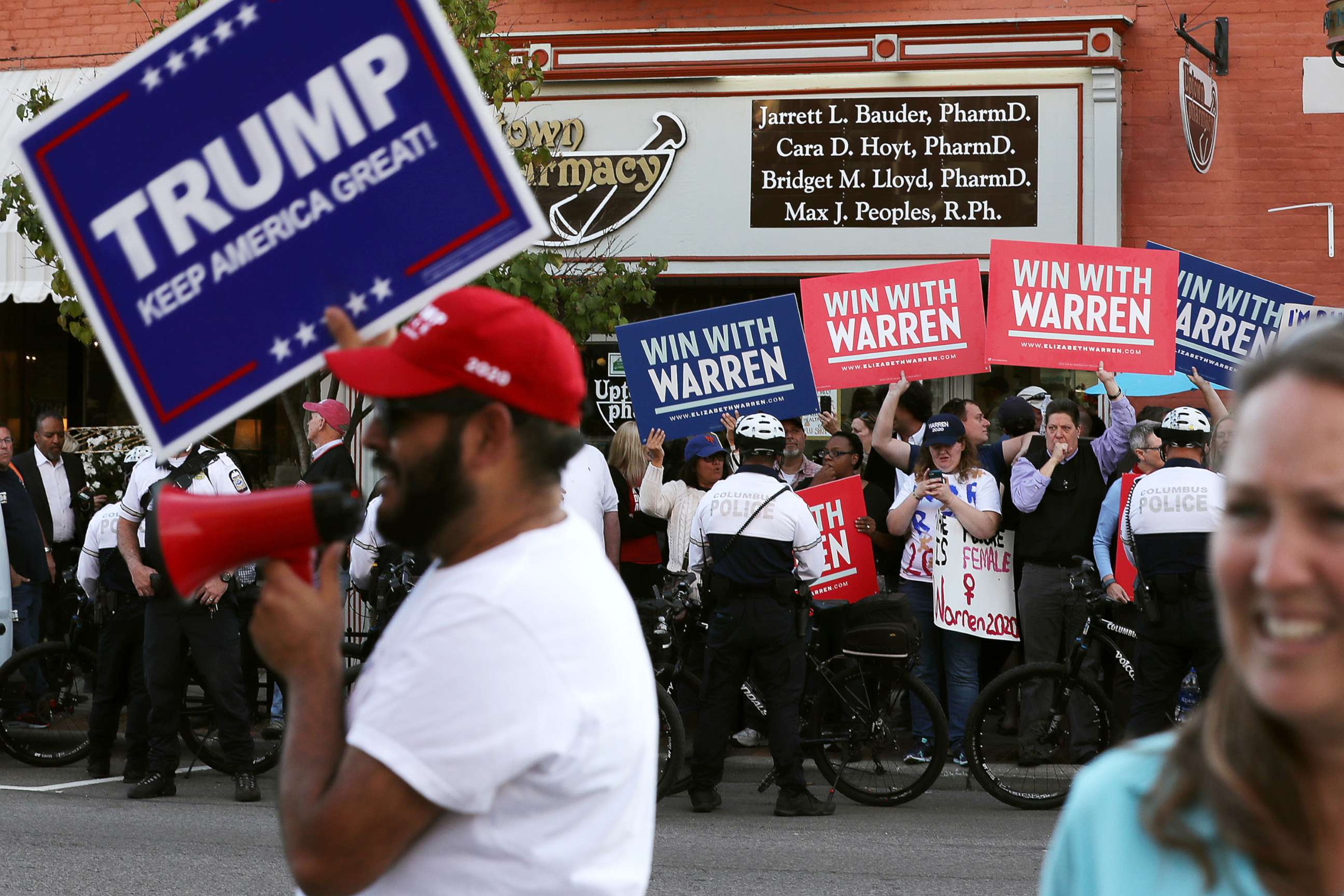 PHOTO: Supporters of resident Donald Trump and Sen. Elizabeth Warren rally on opposite corners near the perimeter of the fourth Democratic presidential debate Oct. 14, 2019 in Westerville, Ohio.