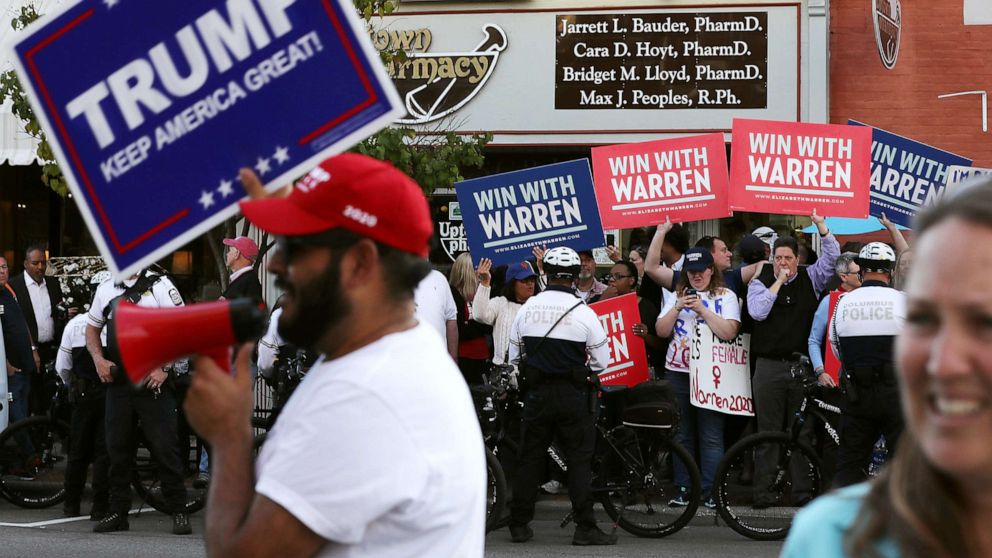PHOTO: Supporters of resident Donald Trump and Sen. Elizabeth Warren rally on opposite corners near the perimeter of the fourth Democratic presidential debate Oct. 14, 2019 in Westerville, Ohio.