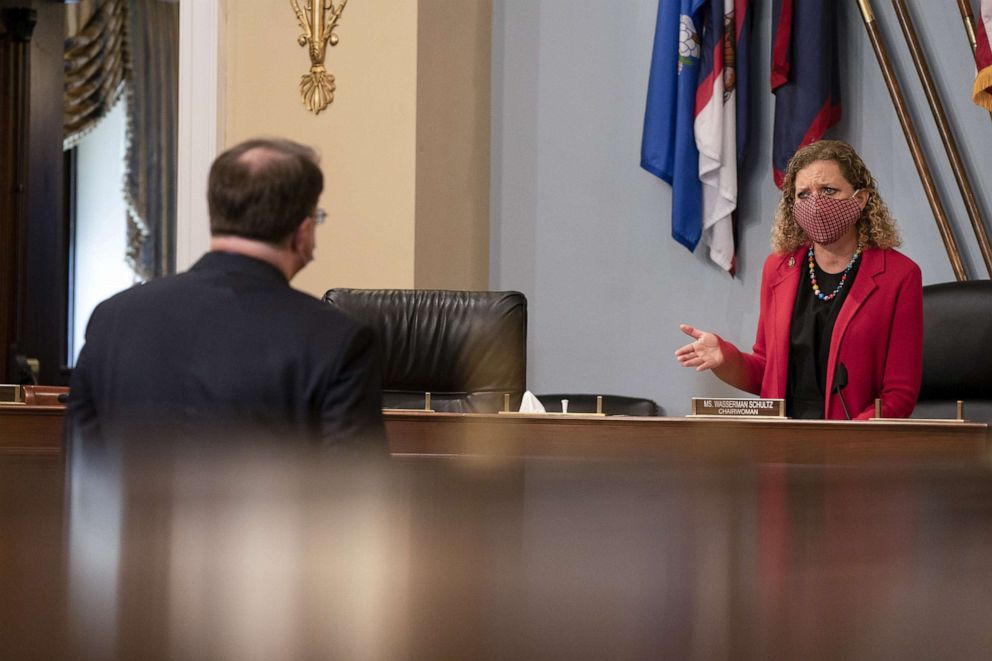 PHOTO: Rep. Debbie Wasserman Schultz, right, and Robert Wilkie, secretary of Veterans Affairs (VA), wear protective masks while talking before a hearing in Washington, D.C., May 28, 2020.
