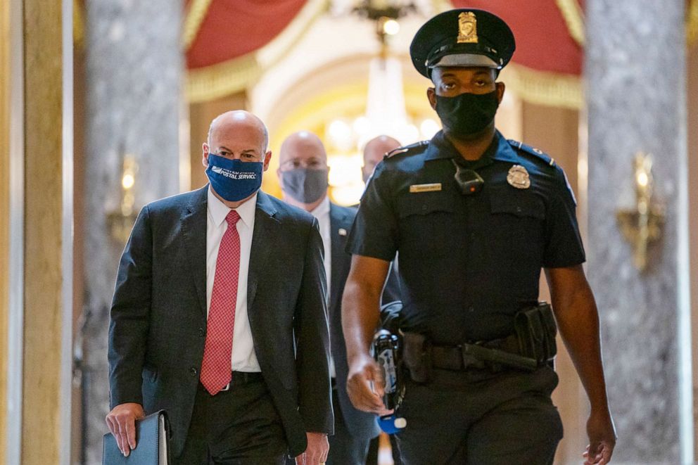 PHOTO: In this Aug. 5, 2020, file photo Postmaster General Louis DeJoy, left, is escorted to House Speaker Nancy Pelosi's office on Capitol Hill in Washington.