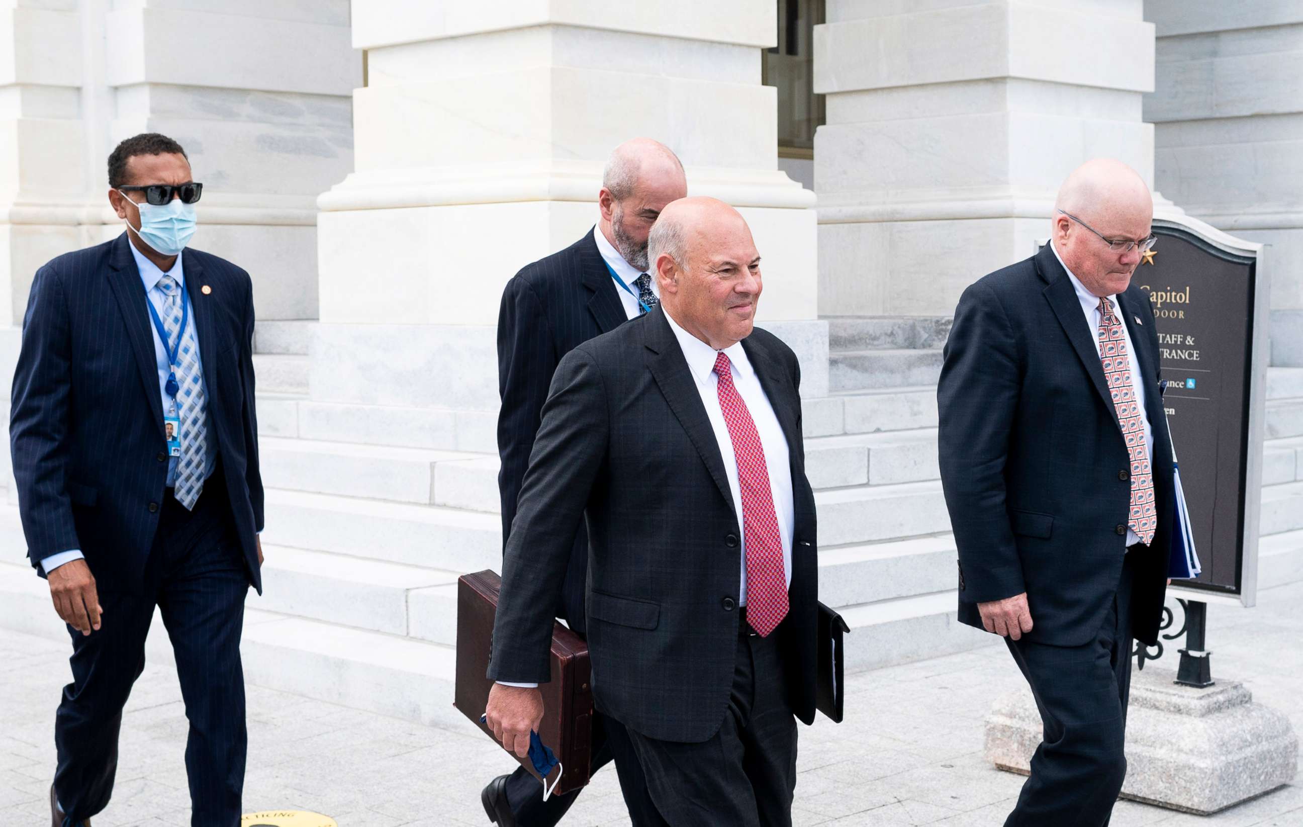 PHOTO: Postmaster General Louis DeJoy, center, leaves the Capitol after meeting with Speaker of the House Nancy Pelosi, D-Calif.,and Senate Minority Leader Chuck Schumer, D-N.Y., Aug. 5, 2020. 