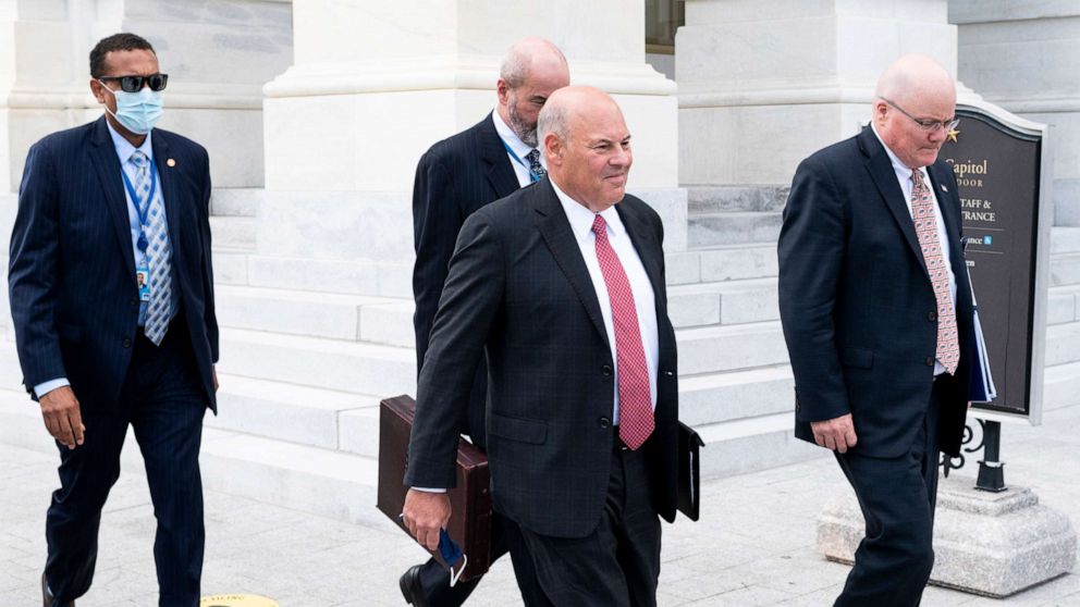 PHOTO: Postmaster General Louis DeJoy, center, leaves the Capitol after meeting with Speaker of the House Nancy Pelosi, D-Calif.,and Senate Minority Leader Chuck Schumer, D-N.Y., Aug. 5, 2020. 