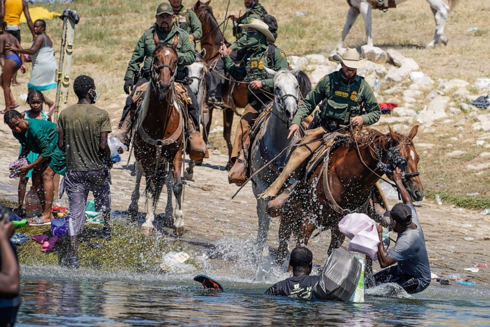 PHOTO: United States Border Patrol agents on horseback try to stop Haitian migrants from entering an encampment on the banks of the Rio Grande near the Acuna Del Rio International Bridge in Del Rio, Texas on Sept. 19, 2021.