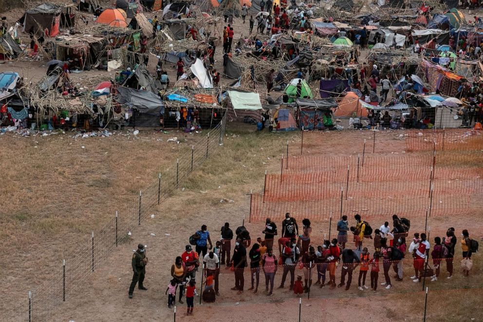 PHOTO: Migrants are prepared for transport as others await to be processed in a makeshift camp along the International Bridge in Del Rio, Texas, Sept. 21, 2021.