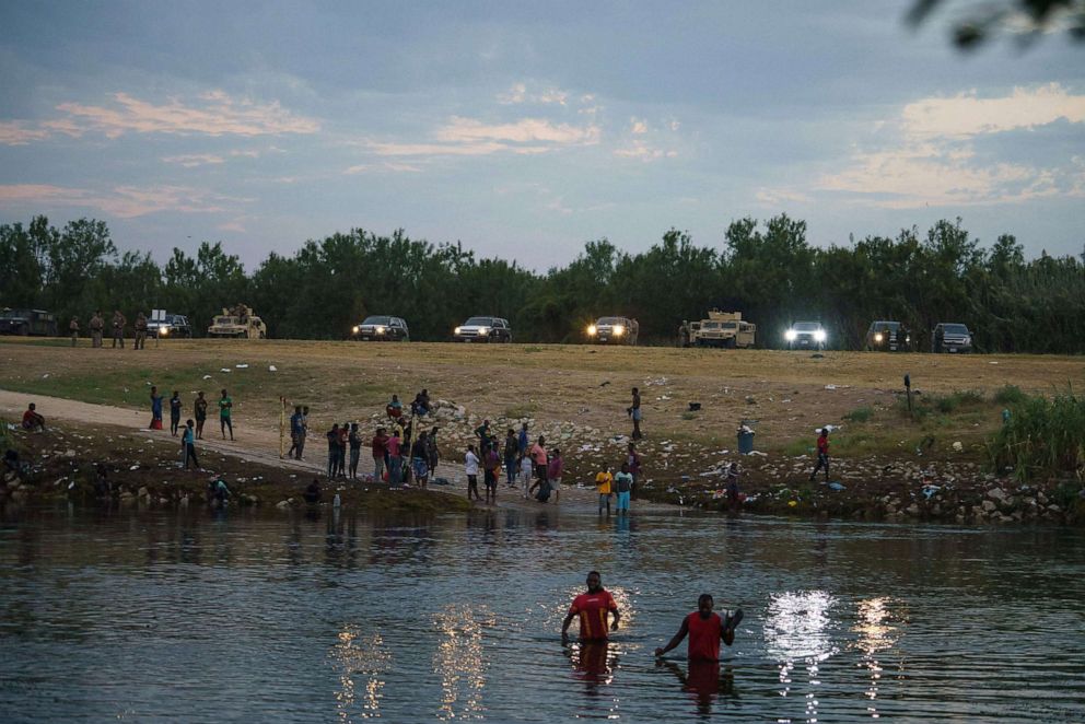 PHOTO: Haitian migrants cross the Rio Grande at dawn from Del Rio, Texas to Ciudad Acuna, Coahuila state, Mexico, Sept. 21, 2021.