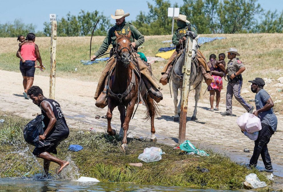 PHOTO: United States Border Patrol agents on horseback try to stop Haitian migrants from entering an encampment on the banks of the Rio Grande near the Acuna Del Rio International Bridge in Del Rio, Texas on Sept. 19, 2021.