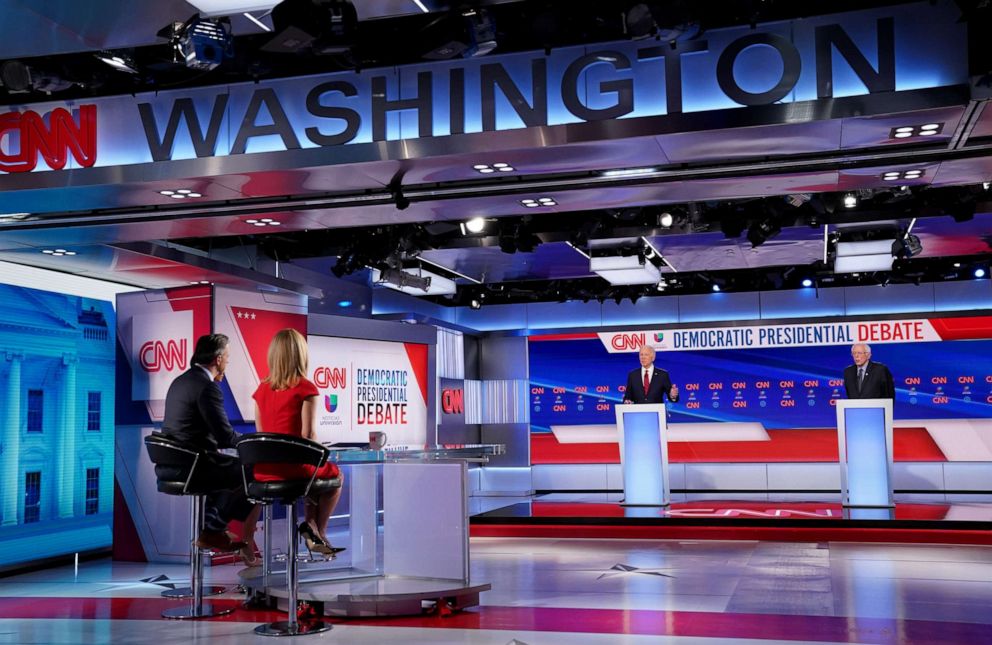 PHOTO: Moderators look on as Democratic presidential candidates former Vice President Joe Biden and Sen. Bernie Sanders take part in the 11th Democratic presidential debate held in CNN's Washington studios in Washington, March 15, 2020.