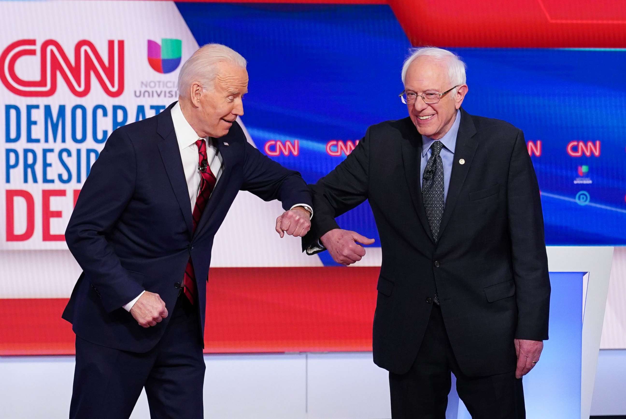 PHOTO: Democratic presidential hopefuls former Vice President Joe Biden and Sen. Bernie Sanders greet each other with an elbow bump as they arrive for the a presidential debate at a CNN Washington Bureau studio, March 15, 2020. 