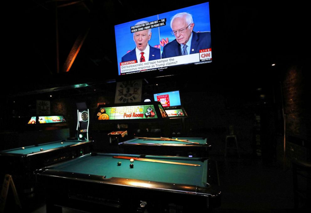 PHOTO: Democratic presidential candidates former Vice President Joe Biden and Sen. Bernie Sanders speak about the coronavirus crisis in a nearly empty restaurant/bar during the Democratic presidential debate, March 15, 2020 in Los Angeles.