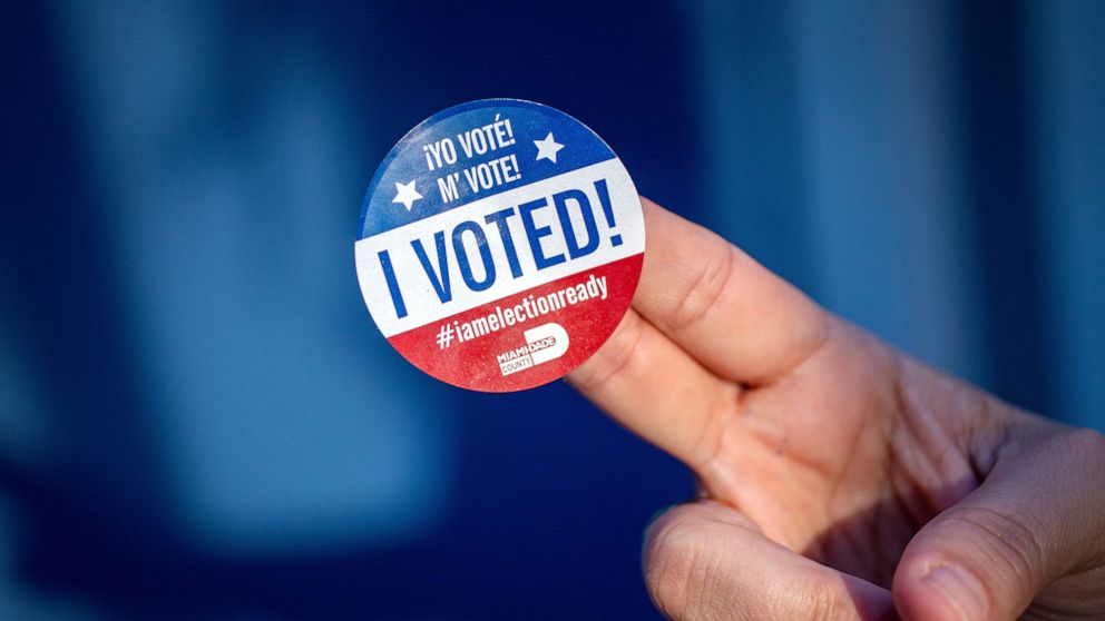 PHOTO: A person shows the Miami-Dade I voted sticker after exercising her vote during the Early Vote in Miami, Nov. 4, 2022.