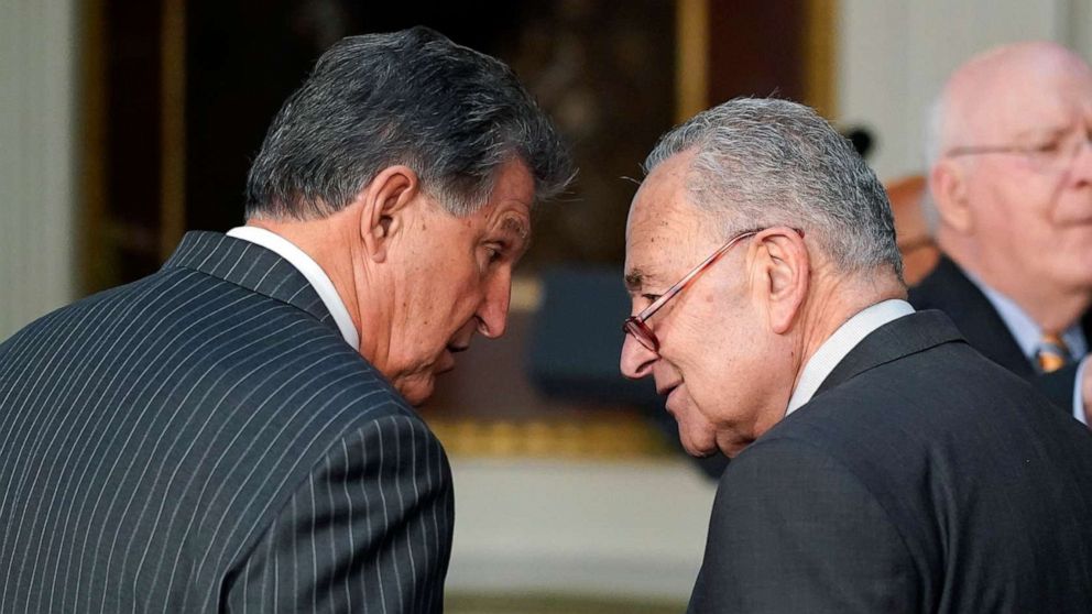 PHOTO: In this March 15, 2022, file photo, Sen. Joe Manchin talks with Senate Majority Leader Chuck Schumer on the White House campus in Washington, D.C.