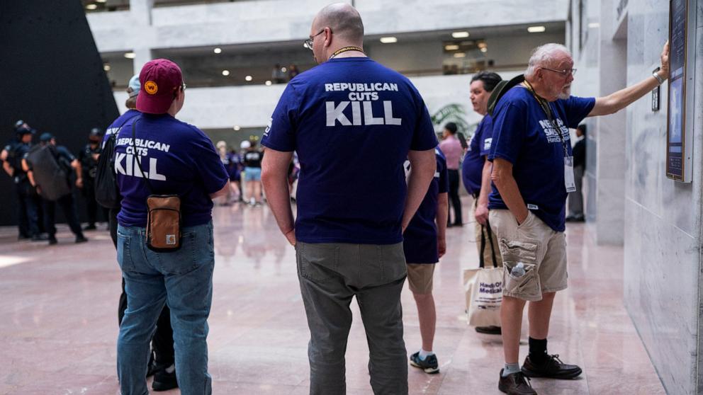 PHOTO: Demonstrators against proposed Republican spending cuts walk through the lobby of the Hart Senate Office Building on Capitol Hill in Washington, D.C., June 25, 2025.