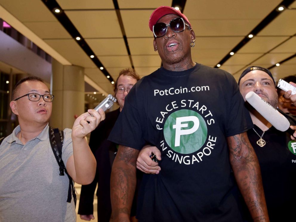 PHOTO: Retired American professional basketball player Dennis Rodman speaks to the press as he arrives at Changi International airport ahead of US-North Korea summit in Singapore, June 11, 2018.