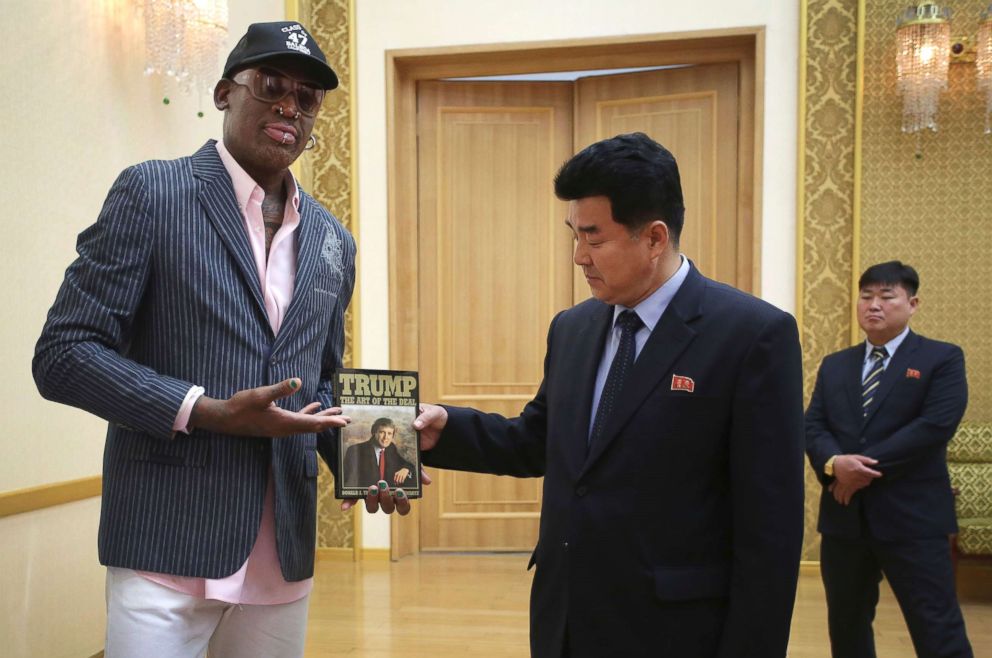 PHOTO: Former NBA basketball star Dennis Rodman presents a book titled "Trump The Art of the Deal" to North Korea's Sports Minister Kim Il Guk on June 15, 2017, in Pyongyang, North Korea.