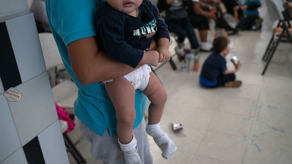 PHOTO: A young mother holds her infant after they arrived on an ICE deportation flight from Brownsville, Texas on Aug. 29, 2019, to Guatemala City.