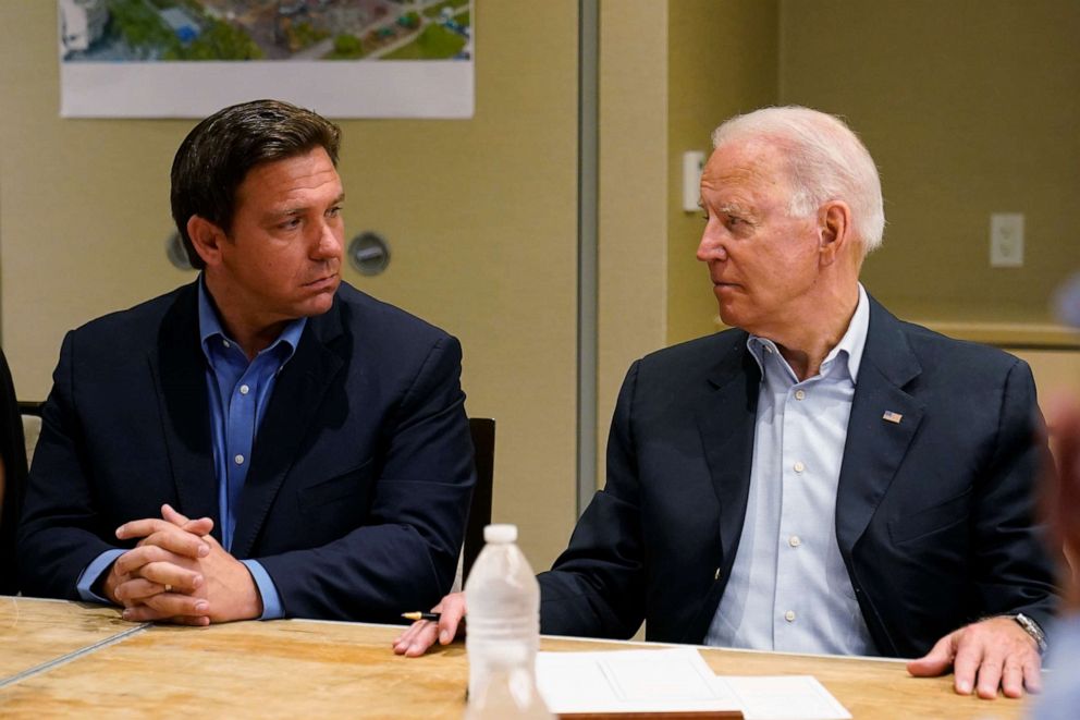 PHOTO: In this July 1, 2021, file photo President Joe Biden, right, looks at Florida Gov. Ron DeSantis, left, during a briefing with first responders and local officials in Miami on the condo tower that collapsed in Surfside, Fla.