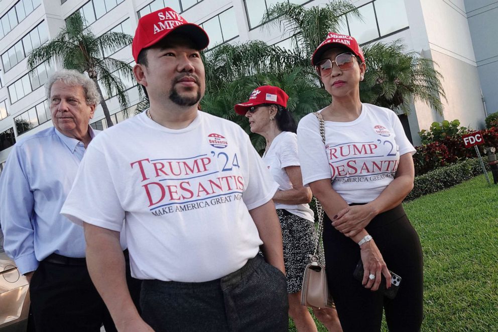 PHOTO: Supporters of Florida Gov. Ron DeSantis, Binh Vo, left, and Trang Le, of Orlando, wait in line for his appearance, May 6, 2021, in West Palm Beach, Fla. 