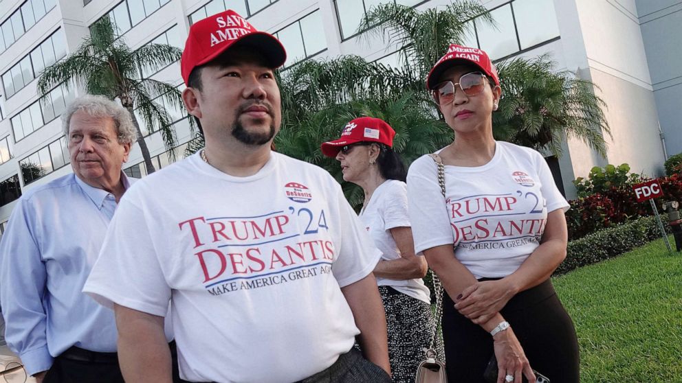 PHOTO: Supporters of Florida Gov. Ron DeSantis, Binh Vo, left, and Trang Le, of Orlando, wait in line for his appearance, May 6, 2021, in West Palm Beach, Florida. DeSantis signed a sweeping elections bill into law.