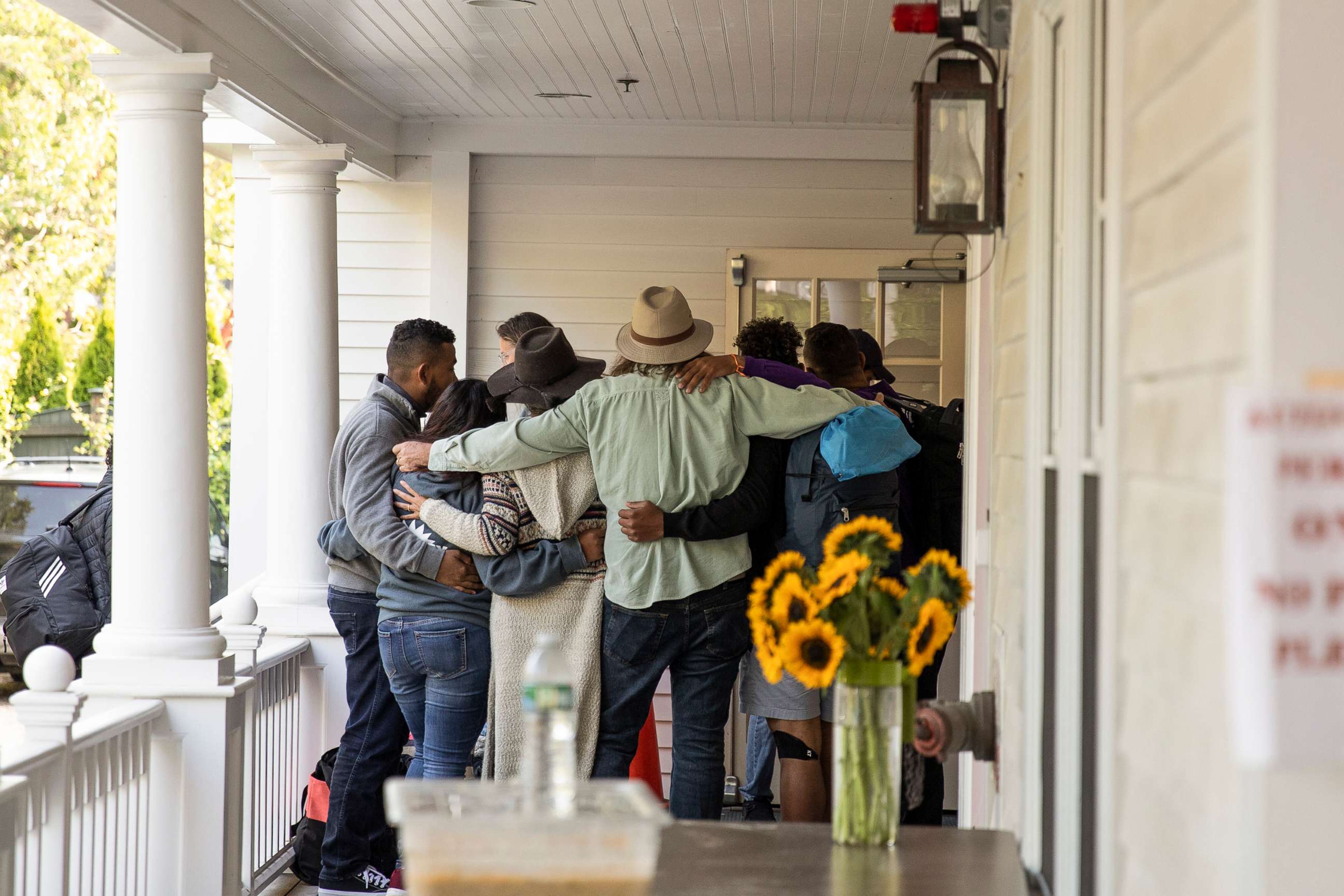 PHOTO: Migrant families say farewell to volunteers before boarding a bus that will take them to the ferry, on Martha's Vineyard in Edgartown, Mass., Sept. 16, 2022.