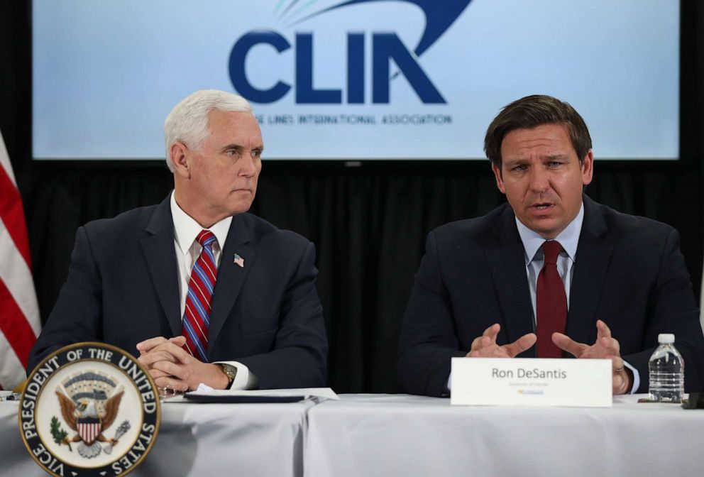 PHOTO: Vice President Mike Pence listens as Florida Governor Ron DeSantis speaks during a discussion held at Port Everglades about COVID-19 issues related to the cruise line industry, March 07, 2020, in Fort Lauderdale, Fla.