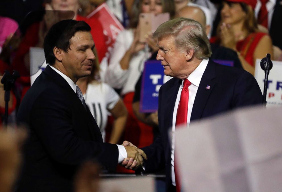 PHOTO: Florida Republican governor candidate, Ron DeSantis, shakes hands with President Donald Trump on July 31, 2018, at a rally in Tampa, Florida. 