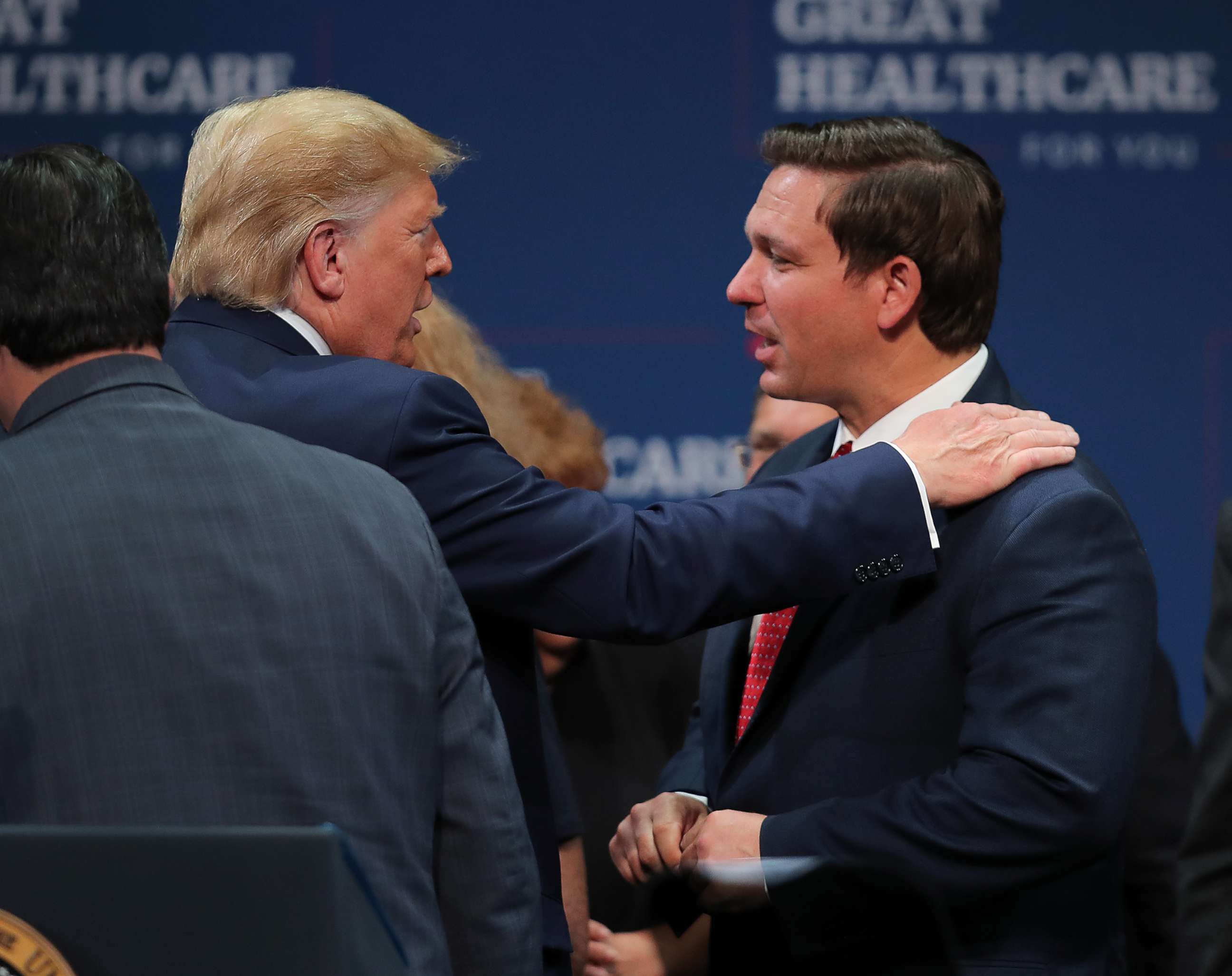 PHOTO: President Donald Trump speaks with Florida Gov. Ron DeSantis during an event at the Sharon L. Morse Performing Arts Center on Oct. 03, 2019, in The Villages, Florida.