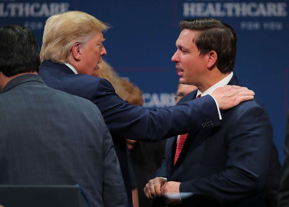 PHOTO: President Donald Trump speaks with Florida Gov. Ron DeSantis during an event at the Sharon L. Morse Performing Arts Center on Oct. 03, 2019, in The Villages, Florida.