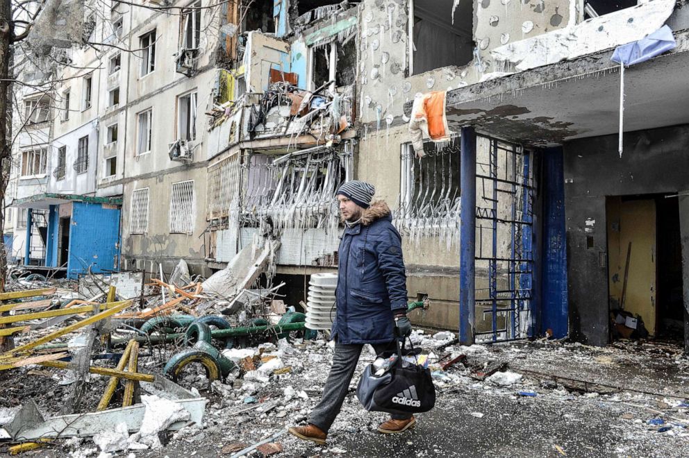 PHOTO: A man leaves an apartment building damaged after shelling the day before in  Kharkiv, Ukraine, on March 8, 2022.