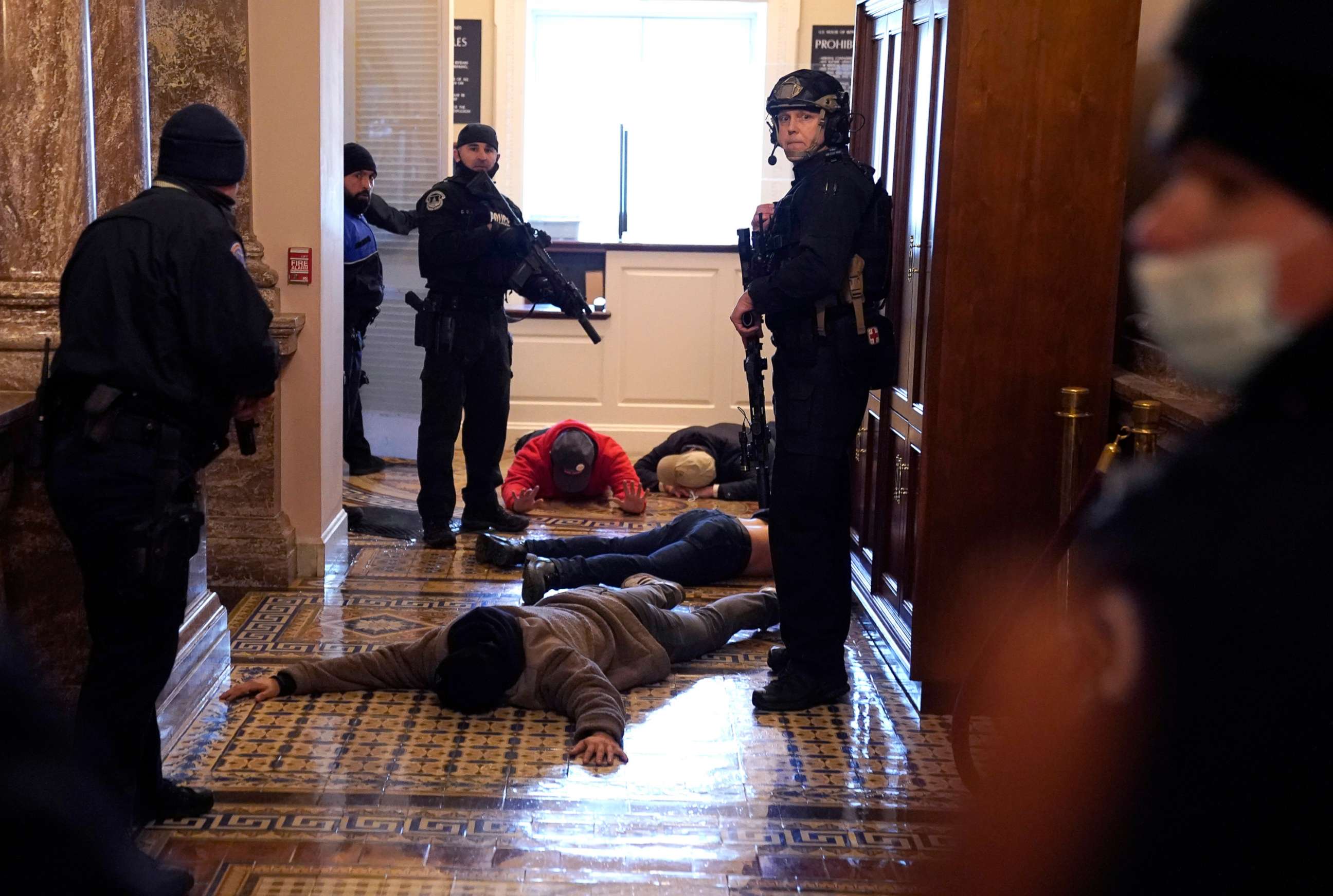PHOTO: U.S. Capitol Police stand detain protesters outside of the House Chamber during a joint session of Congress on Jan. 6, 2021 in Washington, D.C.
