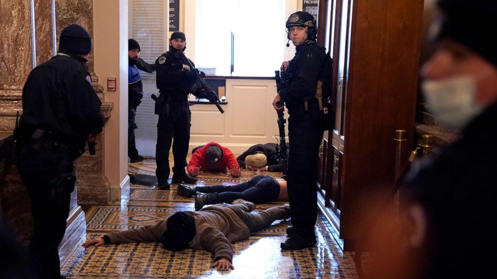 PHOTO: U.S. Capitol Police stand detain protesters outside of the House Chamber during a joint session of Congress on Jan. 6, 2021 in Washington, D.C.