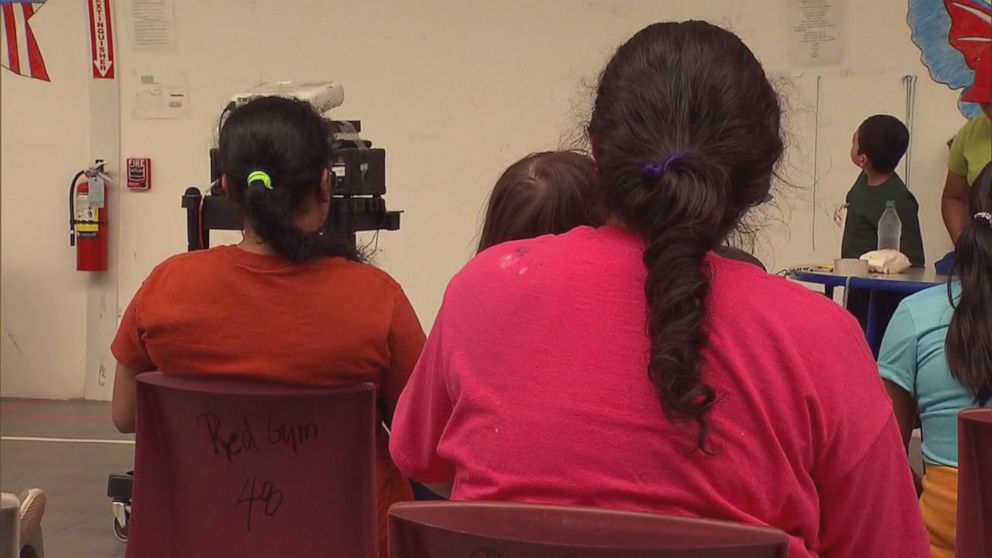 PHOTO: Women and children watch the movie "Coco" in a multi-purpose room at the Immigration and Customs Enforcement family detention center in Dilley, Texas, on August 23, 2019.
