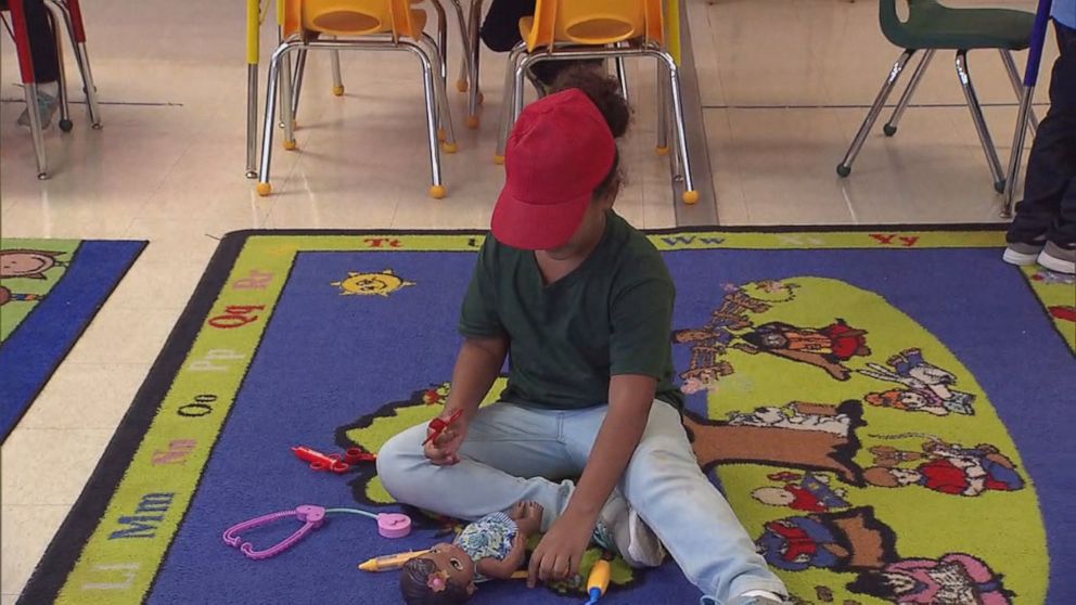 PHOTO: A young child plays with her doll at the Immigration and Customs Enforcement family detention center in Dilley, Texas, on August 23, 2019. 