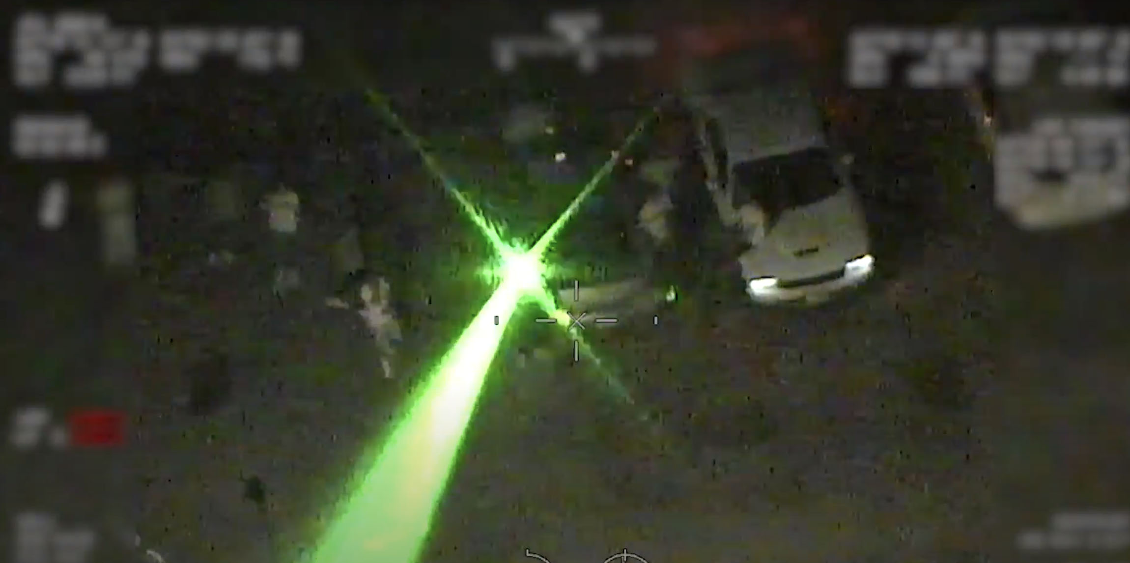 PHOTO: A U.S. CBP helicopter hovering over crowds of people at a Detroit protest on June 3, 2020, was struck multiple times by a green laser, fired from a person across the U.S.-Canadian border.