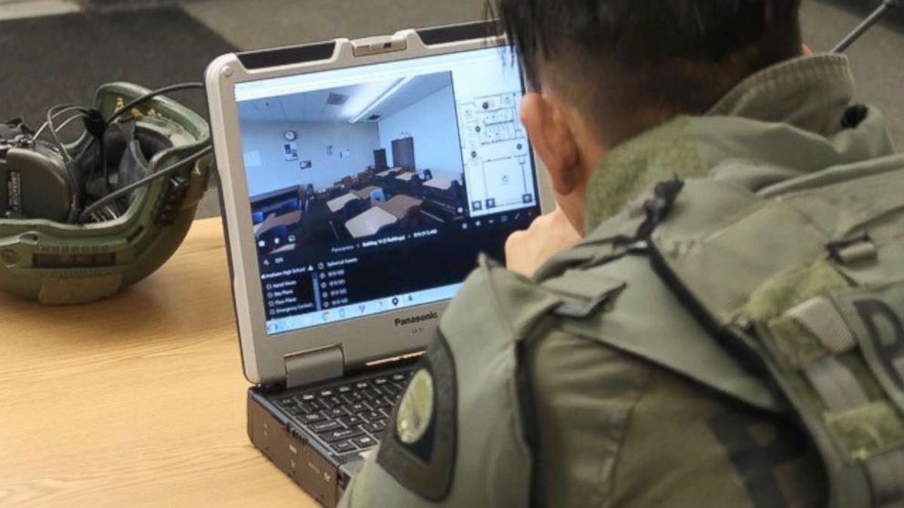 A tactical officer studies a digital-map of Anaheim High School on July 19, 2018, during a training exercise.
