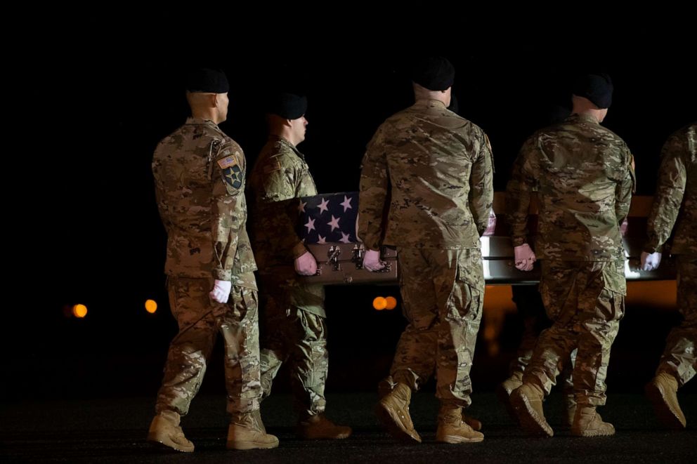 PHOTO: Military personnel carry a transfer case for a service member killed in Afghanistan during a dignified transfer at Dover Air Force Base on Feb. 10, 2020, in Dover, Del.