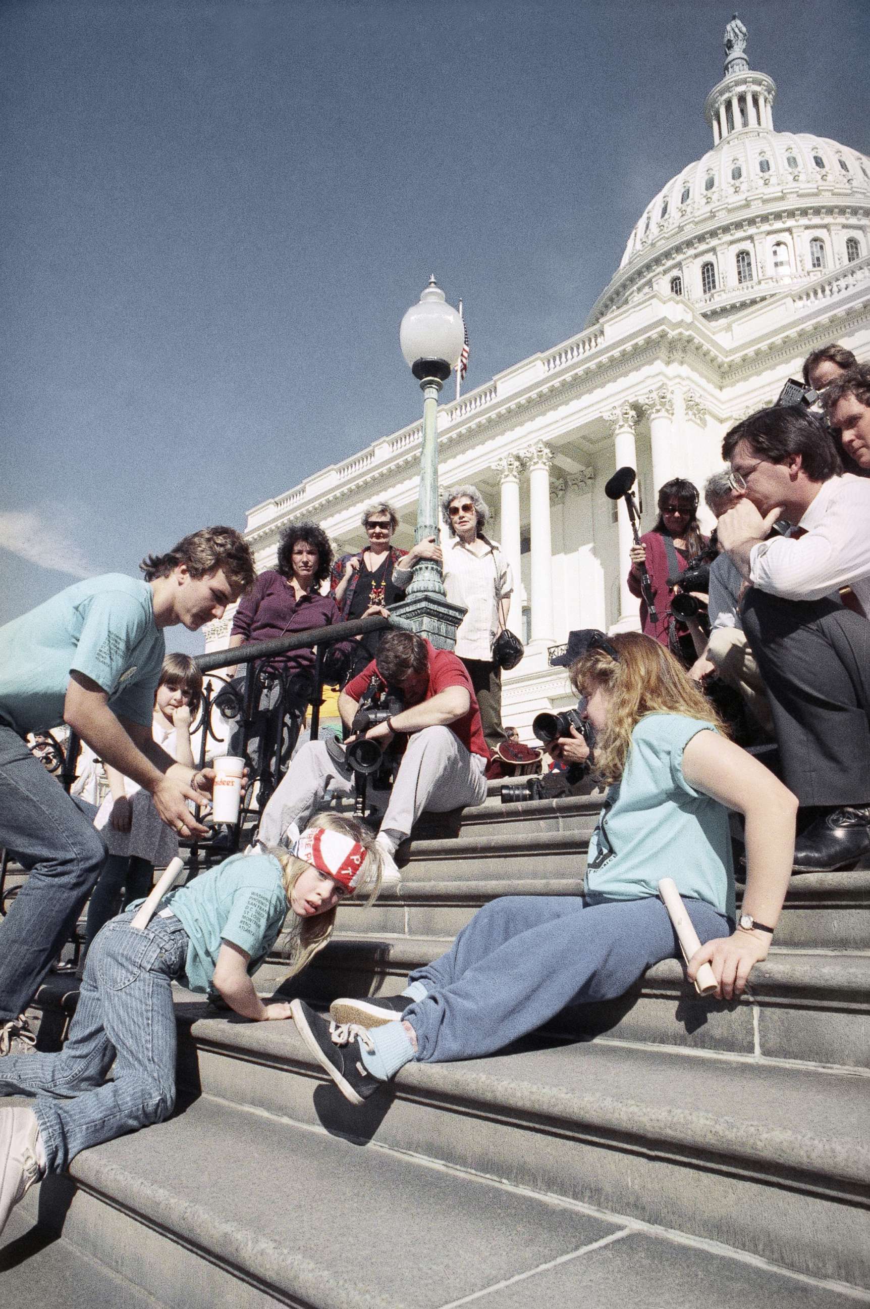 PHOTO: A group of handicapped people led by 8-year-old Jennifer Keelan, left, crawl up the steps of the Capitol in Washington, D.C., March 12, 1990.