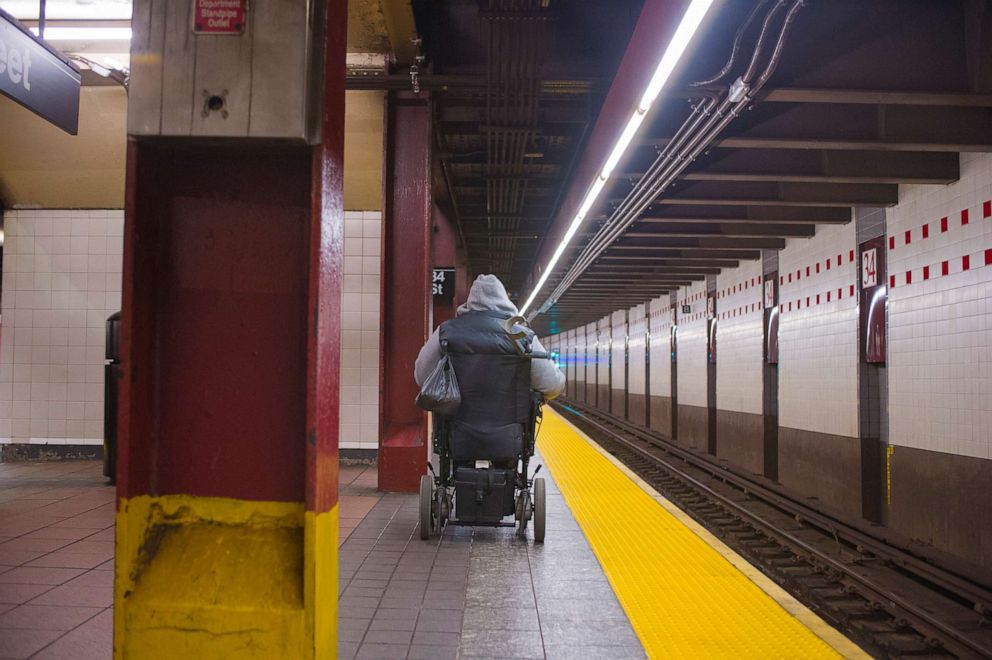 PHOTO: A disabled  man in wheelchair waits fora subway train in New York, Nov. 29, 2013.