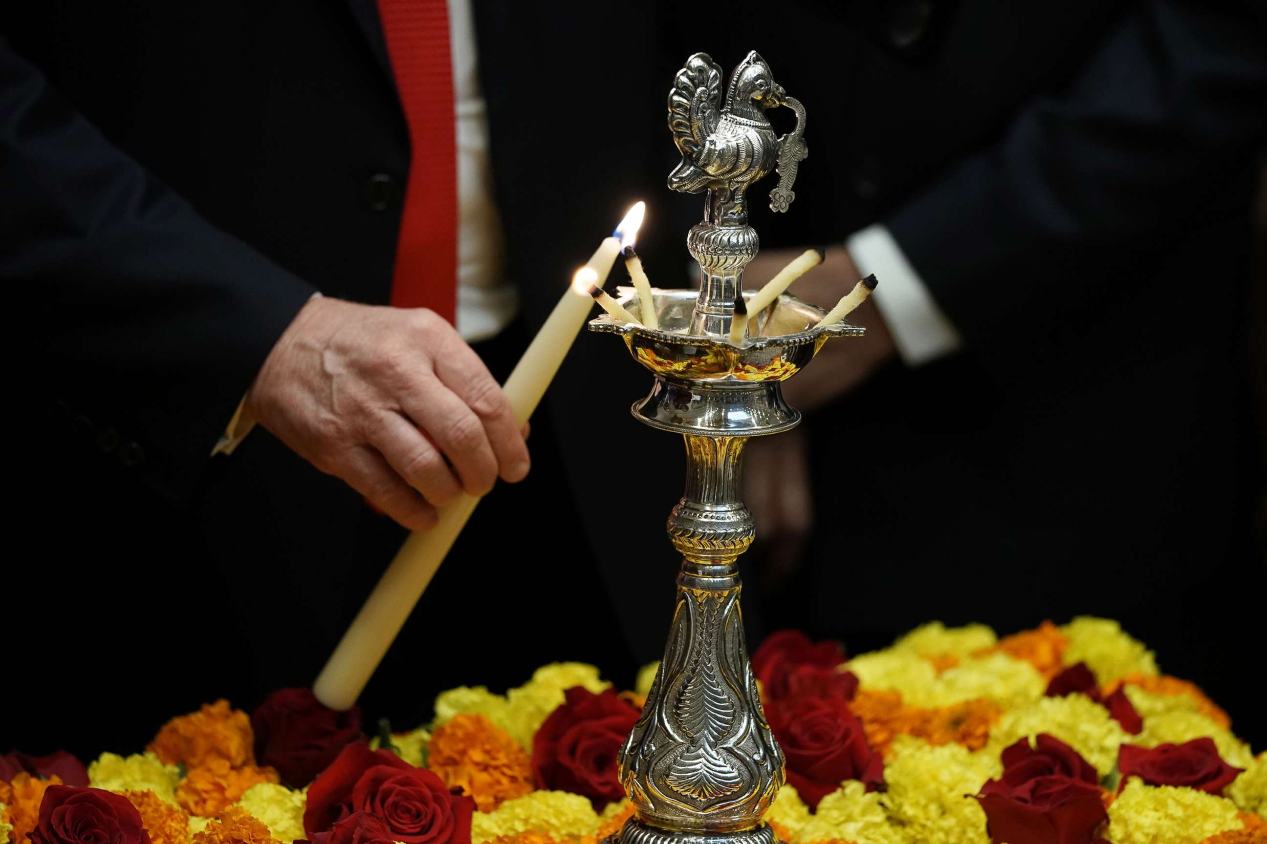 PHOTO: President Donald Trump lights a diya as during a Diwali ceremony in the Roosevelt Room of the White House, Nov. 13, 2018.