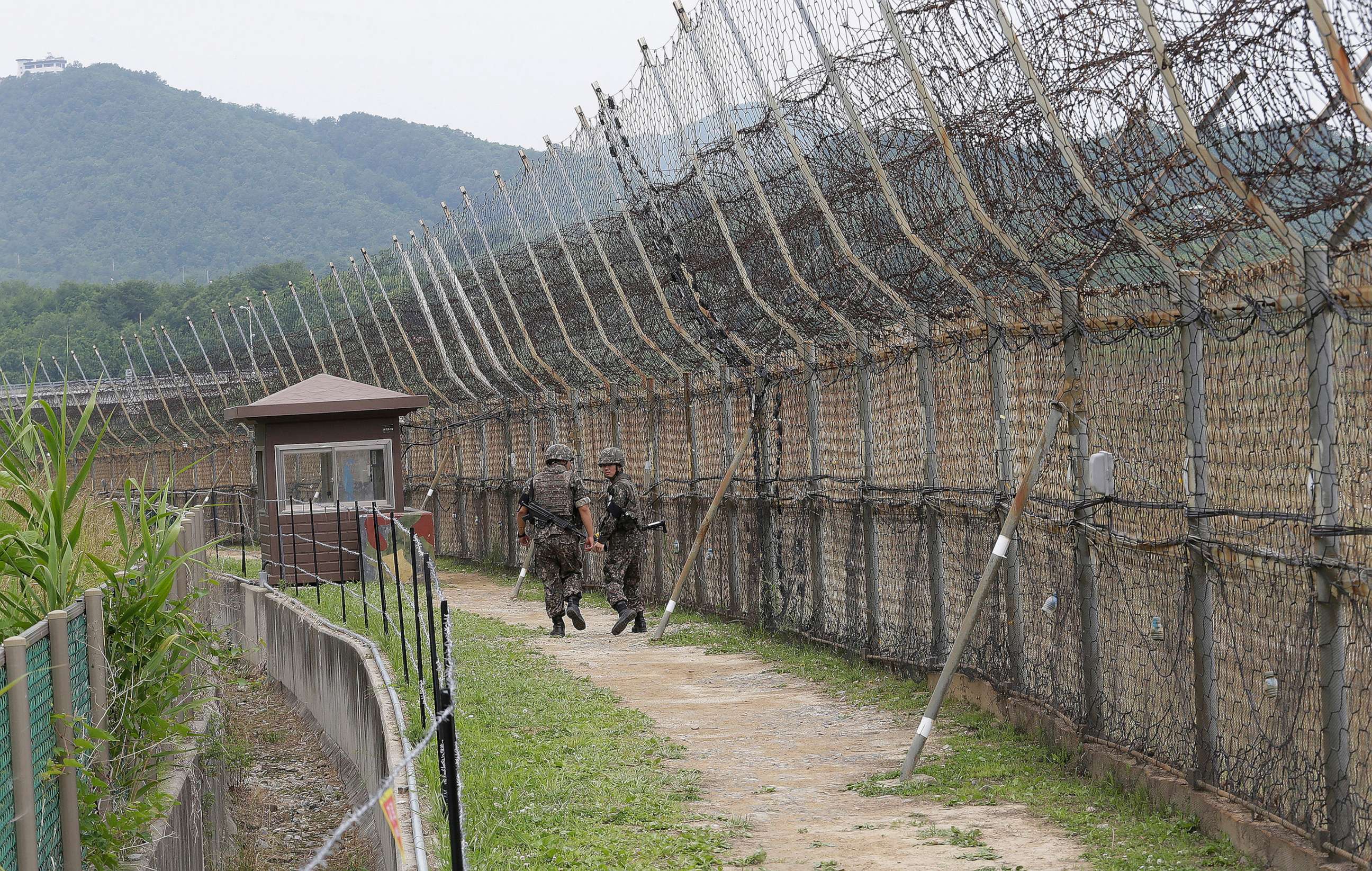 PHOTO: South Korean soldiers patrol while hikers visit the DMZ Peace Trail in the demilitarized zone in Goseong, South Korea on June 14, 2019.