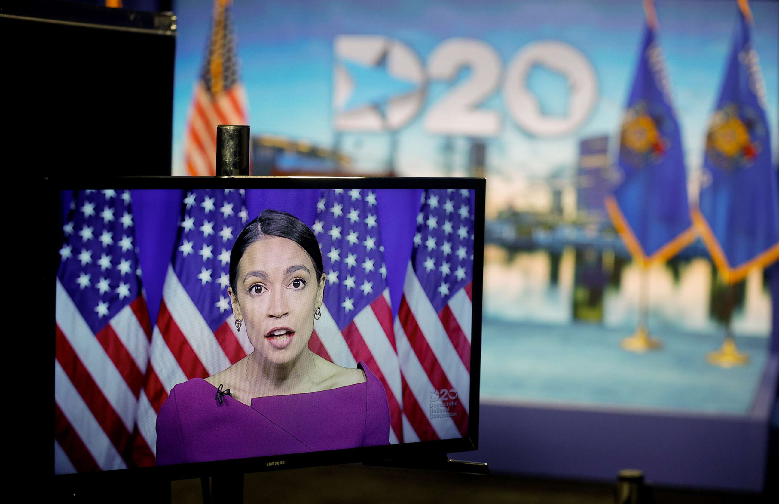 PHOTO: Rep. Alexandria Ocasio-Cortez addresses the second night of the virtual 2020 Democratic National Convention as she seconds the nomination of Senator Bernie Sanders via video feed, Aug. 18, 2020, with the stage in Milwaukee behind the TV screen.