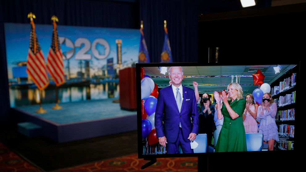 PHOTO: Democratic presidential nominee former Vice President Joe Biden celebrates via video feed from Delaware with his wife Dr. Jill Biden and his grandchildren after following roll call on the second night of the 2020 Democratic National Convention.