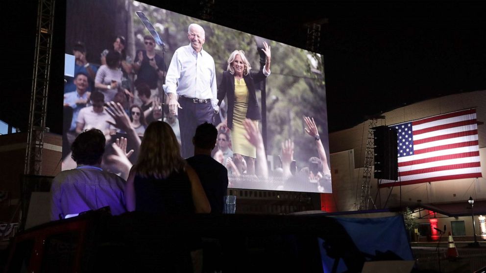 PHOTO: People listen to the Democratic National Convention being broadcast in a parking lot outside Chase Center in Wilmington, Del., Aug. 20, 2020.